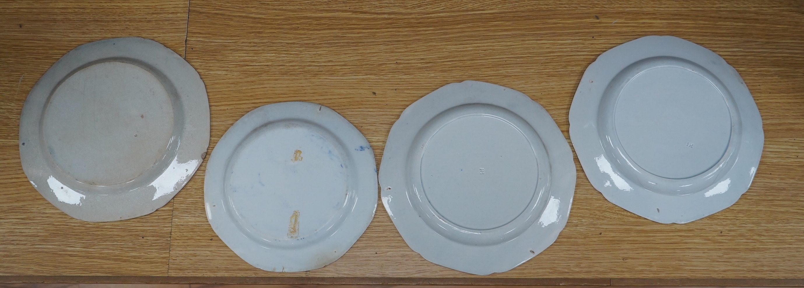 Four early 19th century English pearlware blue and white plates, largest 23.5cm. Condition - fair